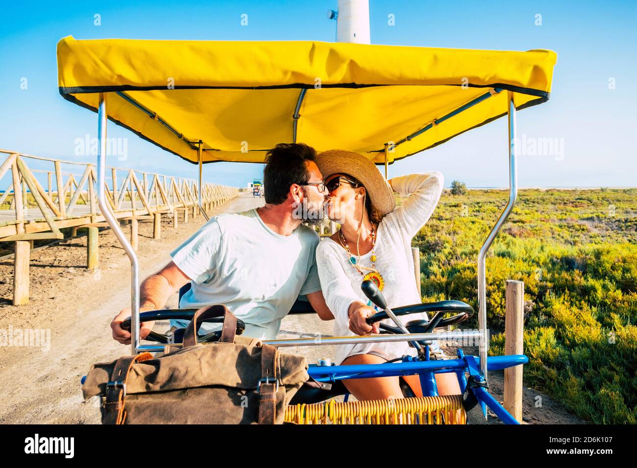 Happy adult couple enjoy and love together in bike outdoor leisure activity during travel vacation - summer people enjoying holidays and having fun to Stock Photo