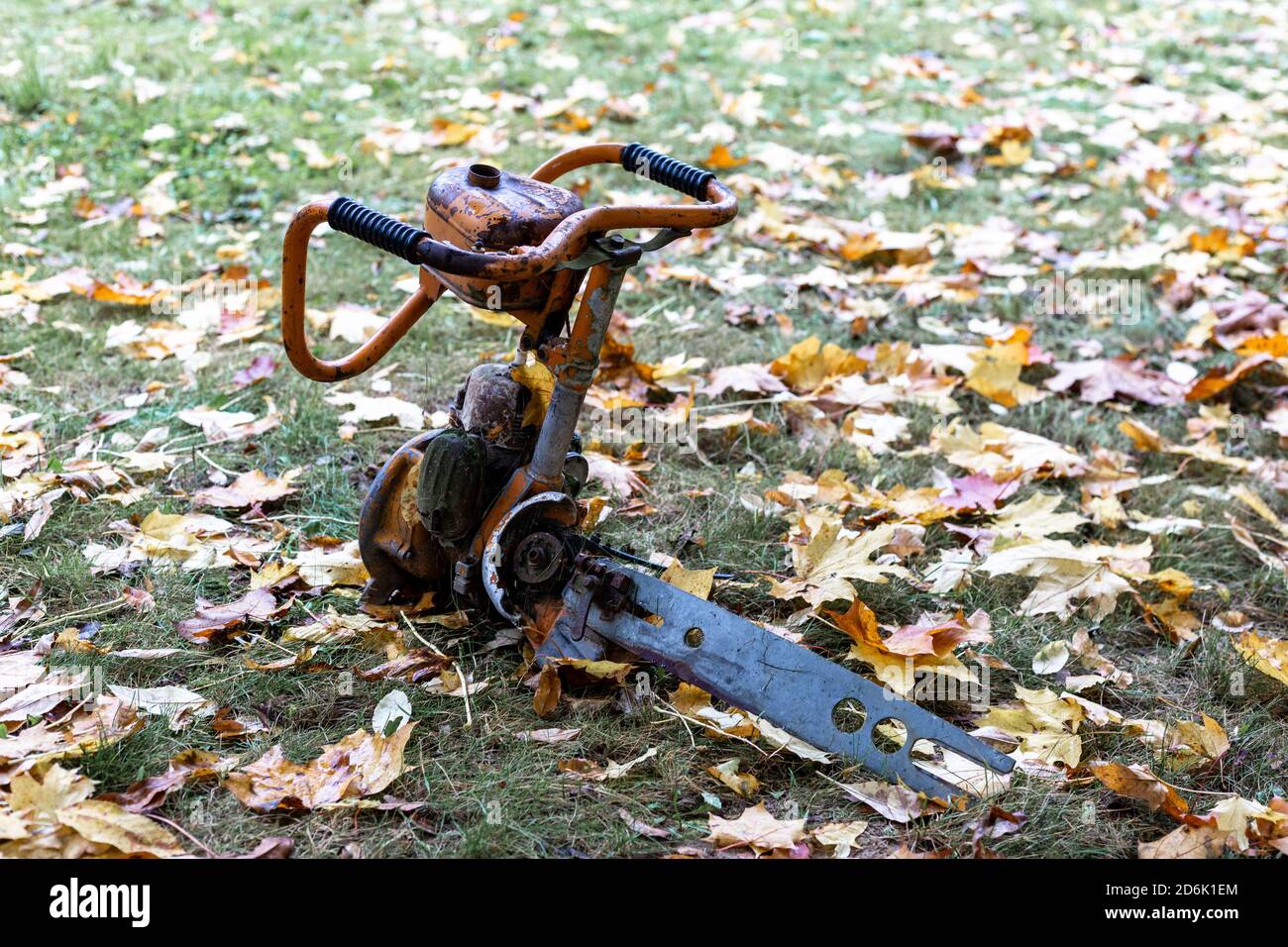 Broken chainsaw on the grass Stock Photo