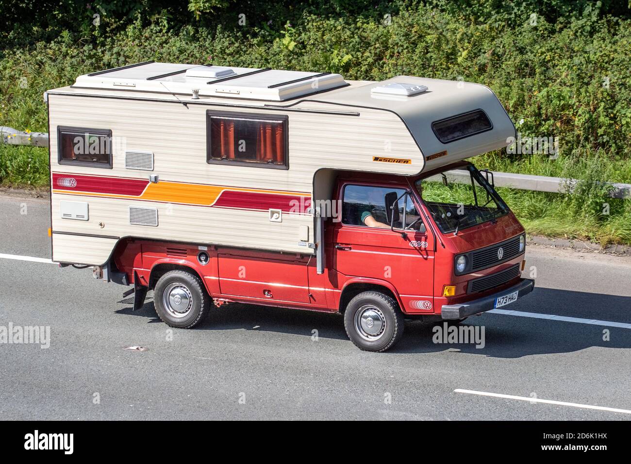 1991 90s white red VW Volkswagen Syncro 4WD Caravans and Motorhomes, campervans on Britain's roads, RV leisure vehicle, family holidays, caravanette vacations, Touring caravan holiday, van conversions, Vanagon autohome on the M61 motorway Stock Photo