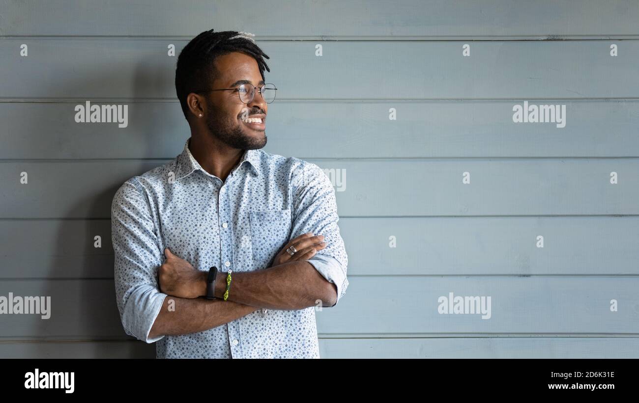 Smiling biracial man look in distance dreaming planning Stock Photo
