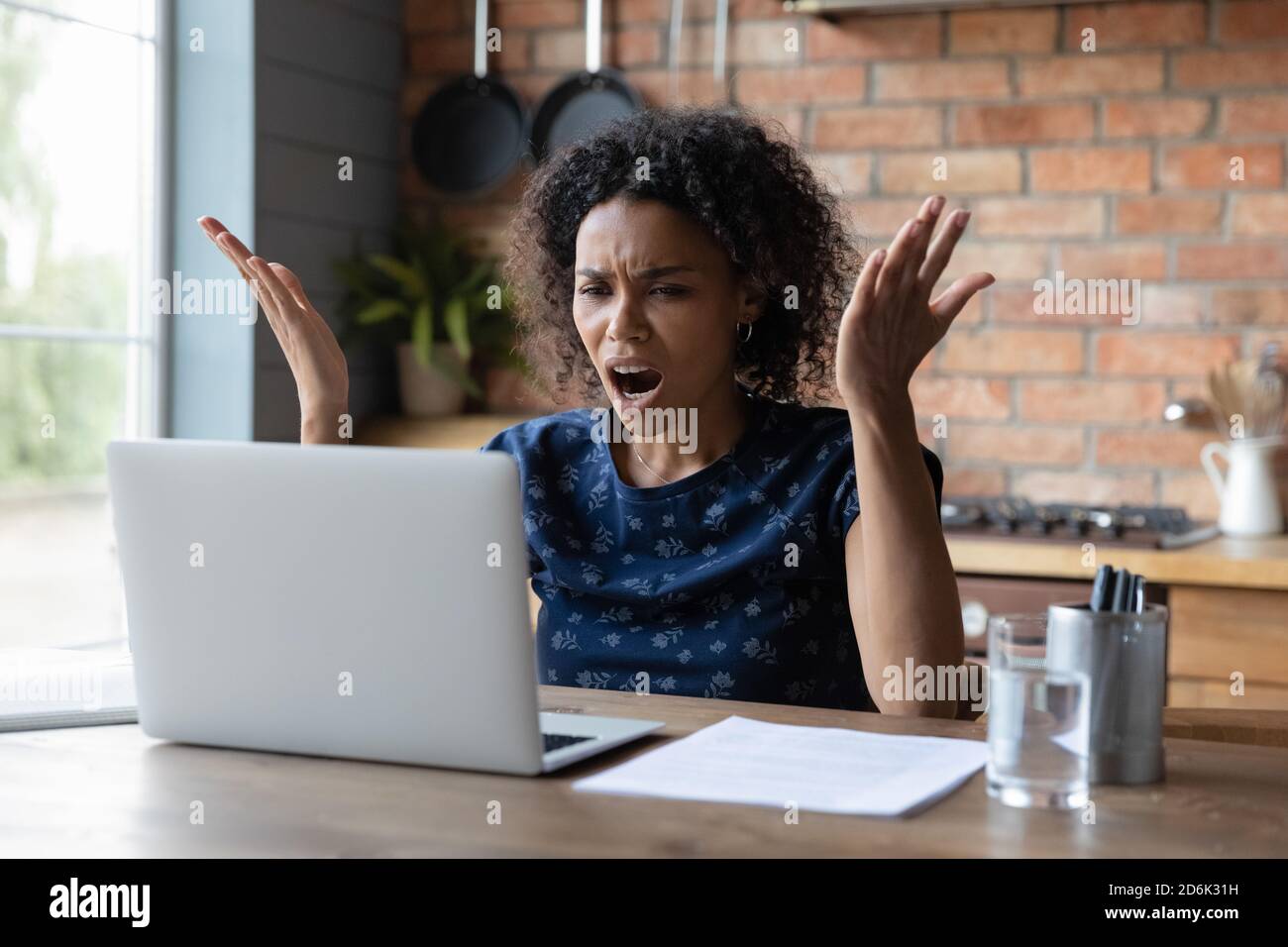 Angry African American woman distressed with computer problem Stock Photo
