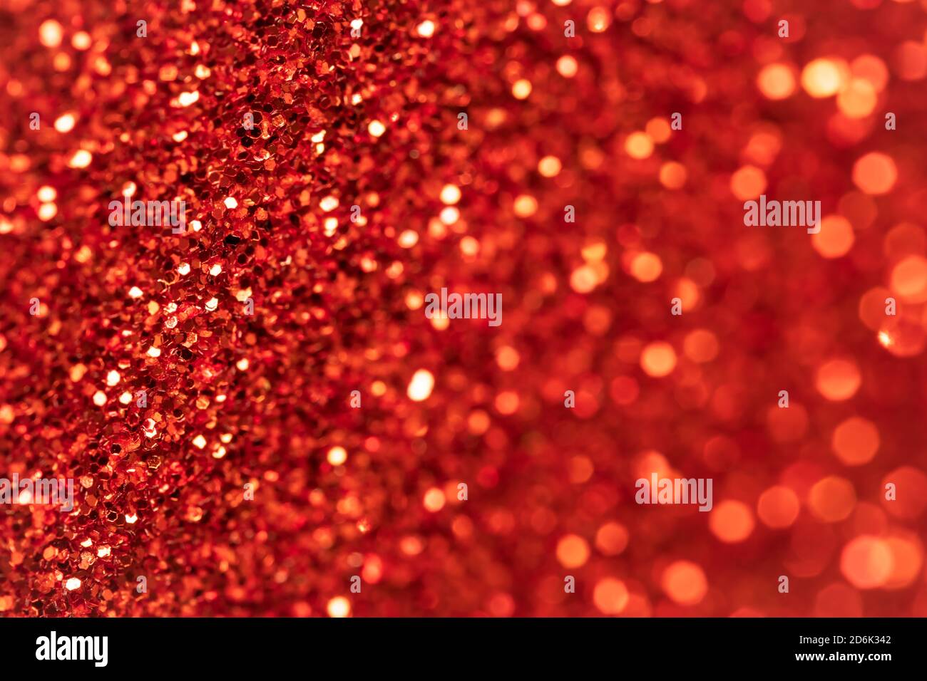 Sparkle red texture, Christmas background. Glitter textile surface. Abstract pattern. Festive abstraction. Shiny fabric with sequins. Holiday art desi Stock Photo