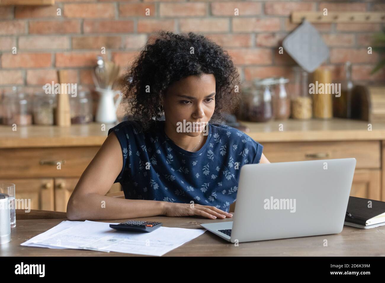 African American woman pay household bills online Stock Photo