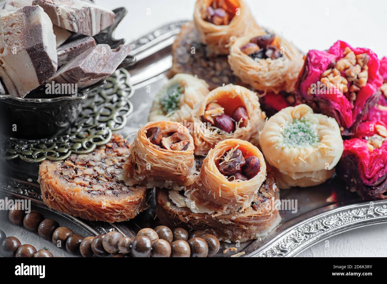 Arabic, Lebanese and Turkish sweets kataifi and kanafeh, a Traditional Eastern dessert made of thin dough with syrup , nuts and seeds. Close up Stock Photo
