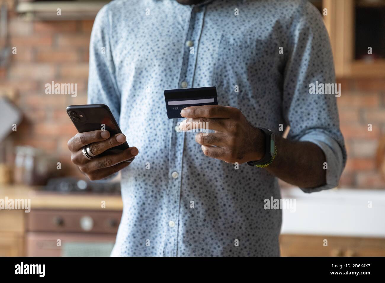 Biracial man shopping online paying with credit card Stock Photo