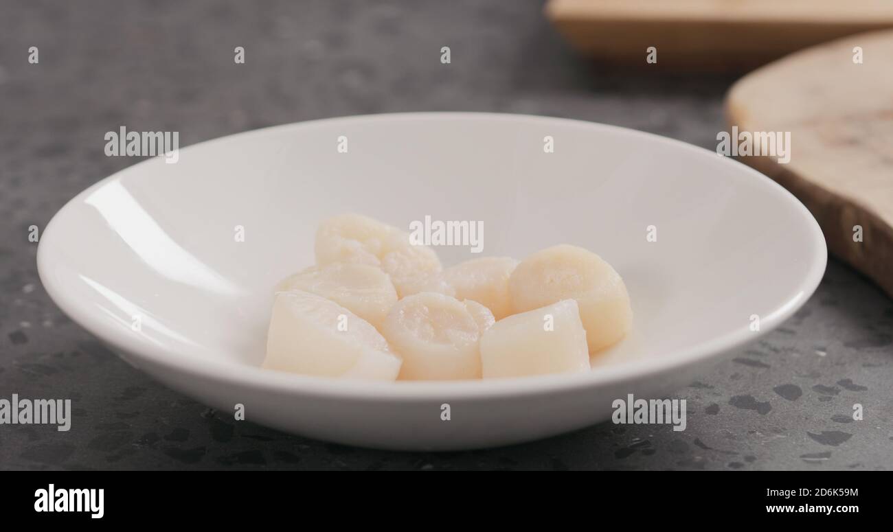 raw scallops before cooking, wide photo Stock Photo Alamy