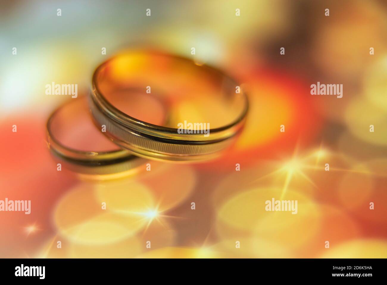 wedding rings in warm colors with reflection Stock Photo