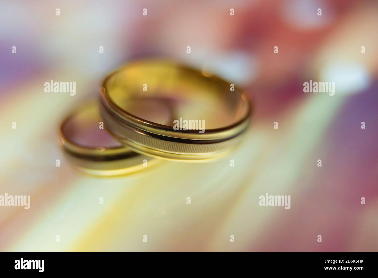 wedding rings in warm colors with reflection Stock Photo