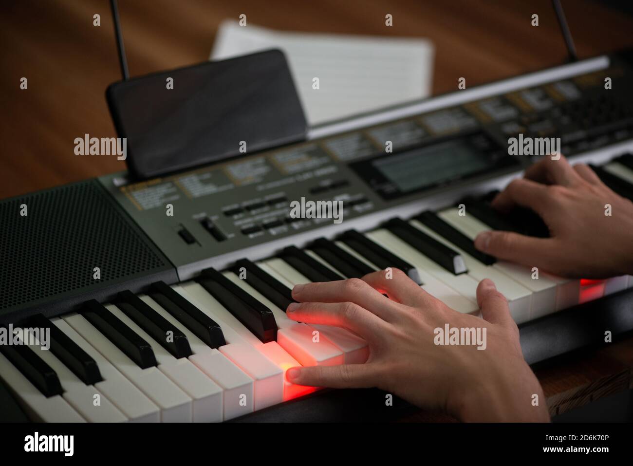 Boy learning to play piano and using an app on his phone Stock Photo - Alamy