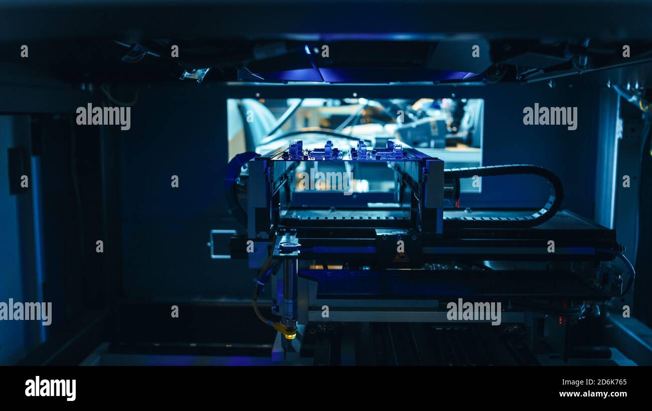 Neon Handler Machine Automated Robotic Industrial Equipment is Testing Electronic Printed ...