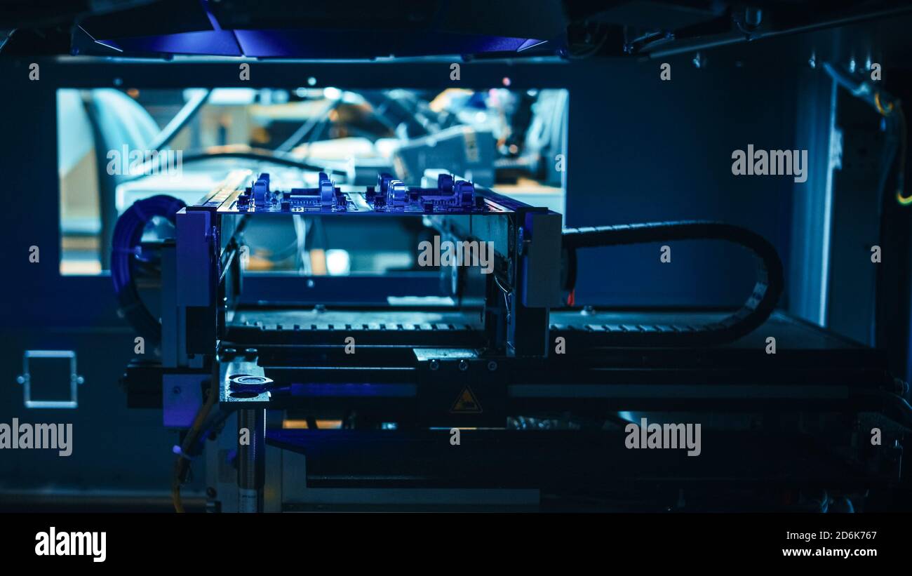 Neon Handler Machine Automated Robotic Industrial Equipment is Testing Electronic Printed ...