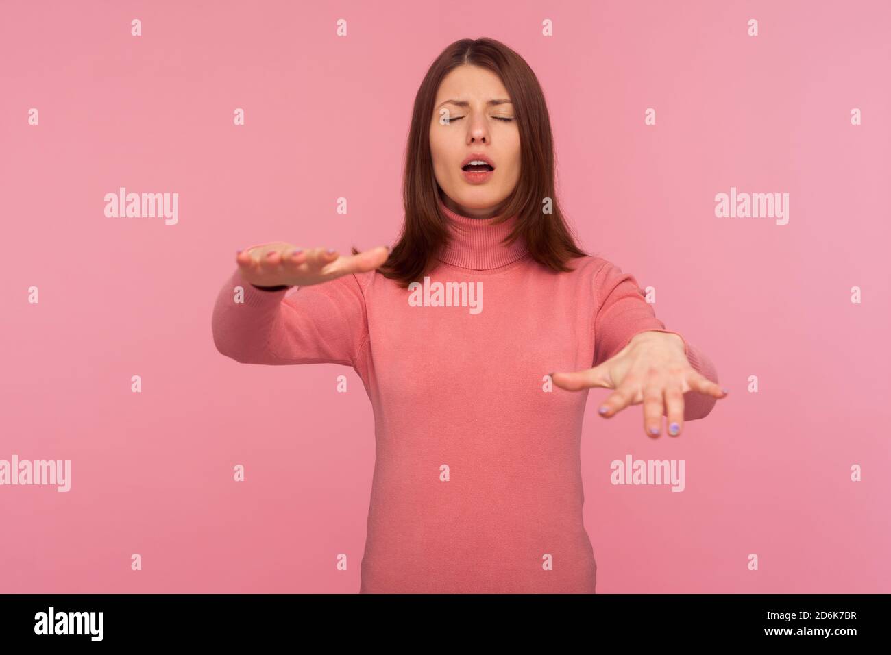 woman with eyesight problems trying to move with closed eyes touching space around with