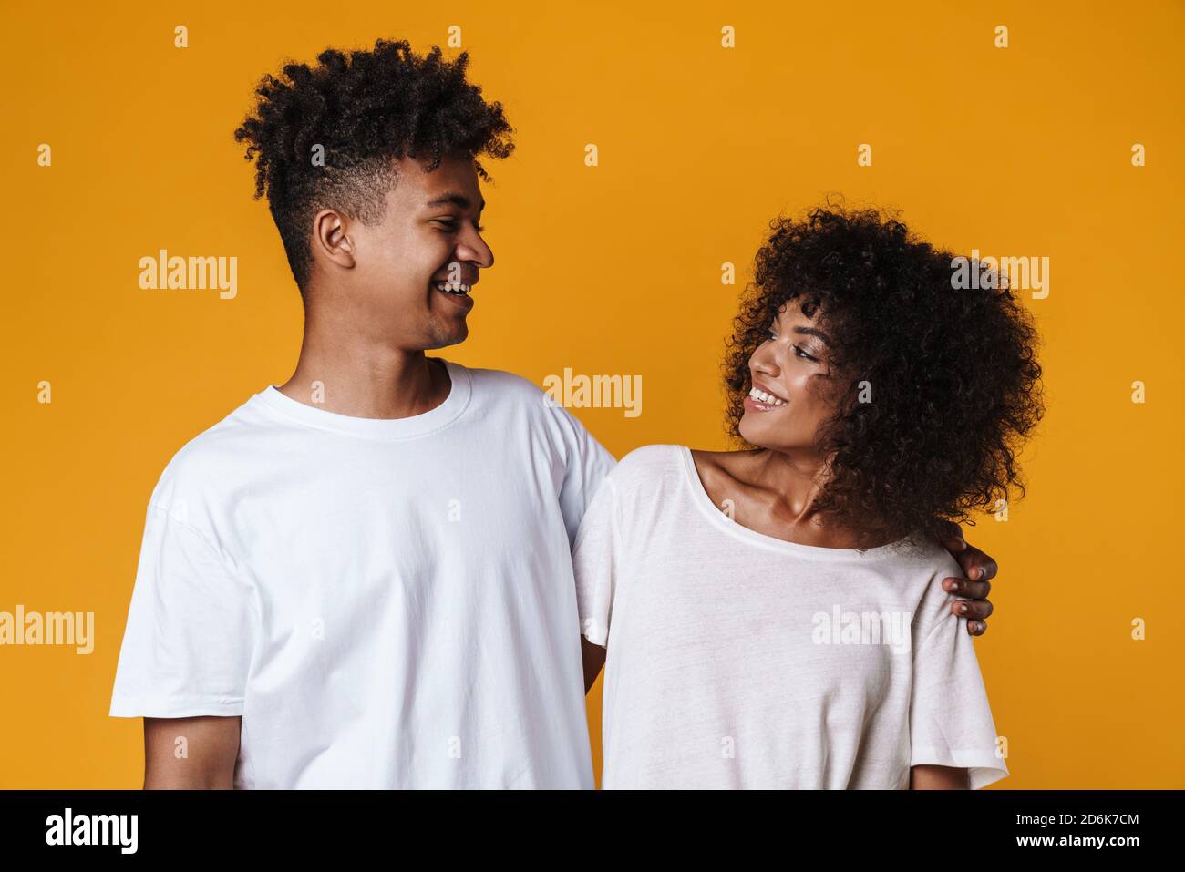 Image of happy african american couple hugging and smiling at camera ...