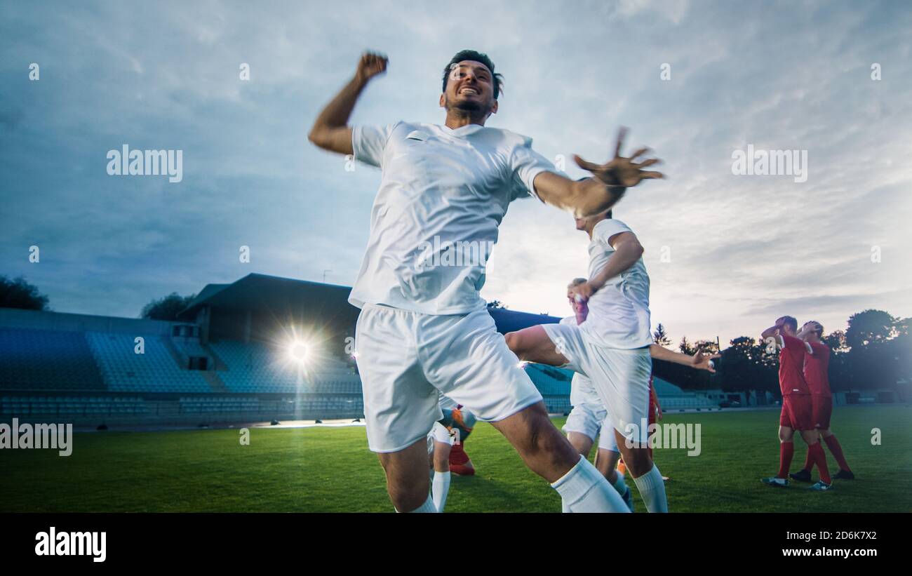 Portrait Shot of Captain of the Soccer Team Celebrates Awesome Victory with His Team, Doing YES Gesture. Team of Celebrate Winning Championship. Stock Photo