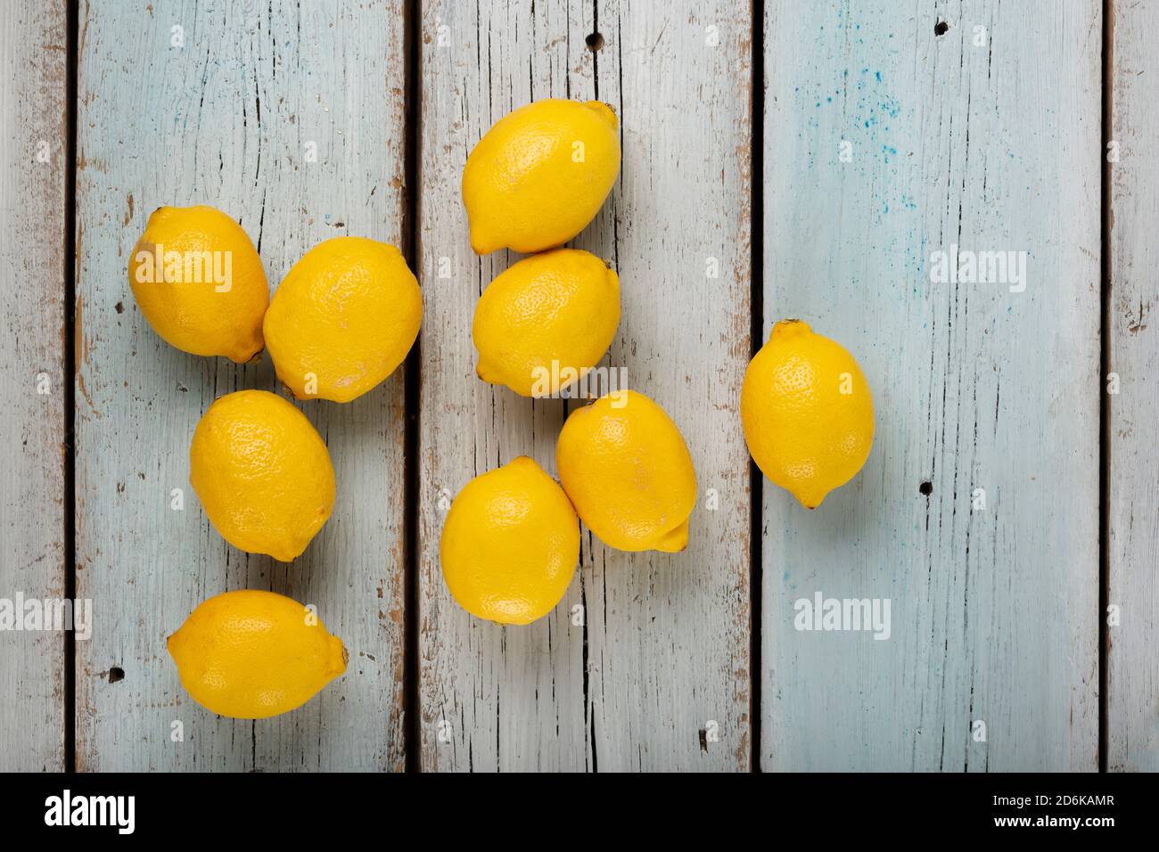 Fresh fragrant lemons on a blue wooden table, top view Stock Photo