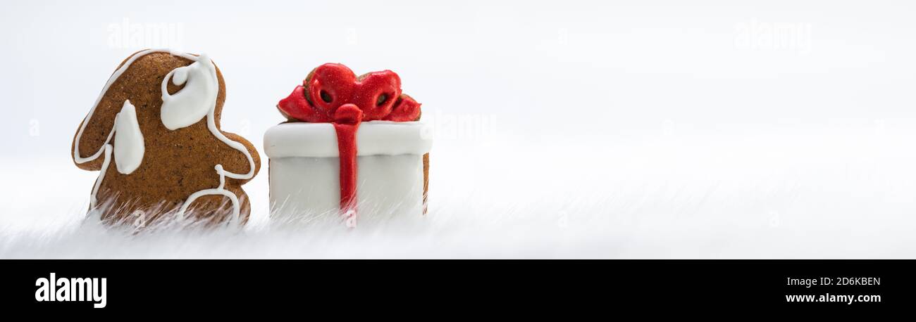 Gingerbread cookies rabbit and gift in snow isolated on white ...