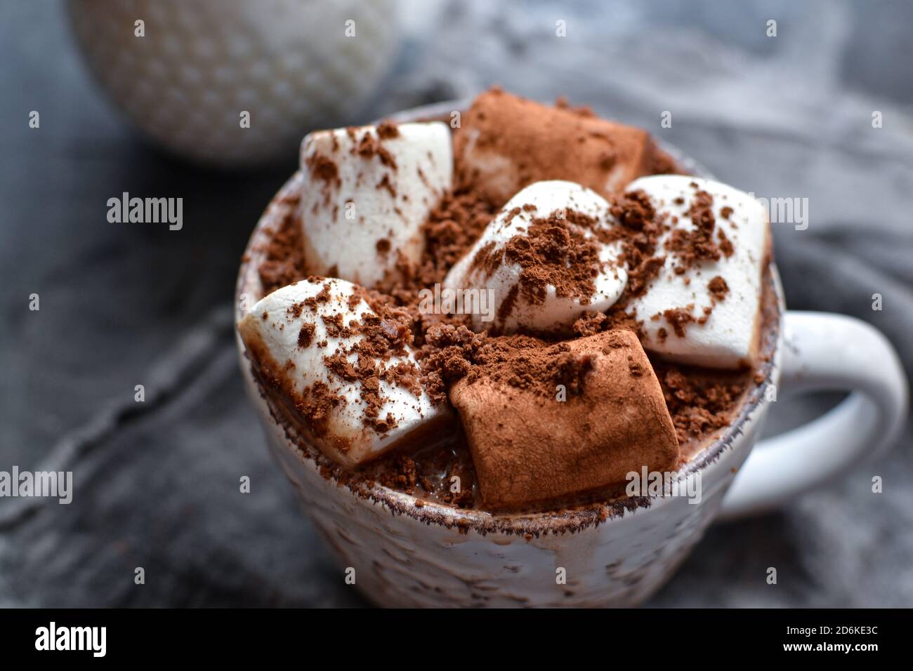 Hot chocolate and marshmallows. Hot Cocoa in a white cup. Dark background. Autumn drink concept. Copy space. Stock Photo