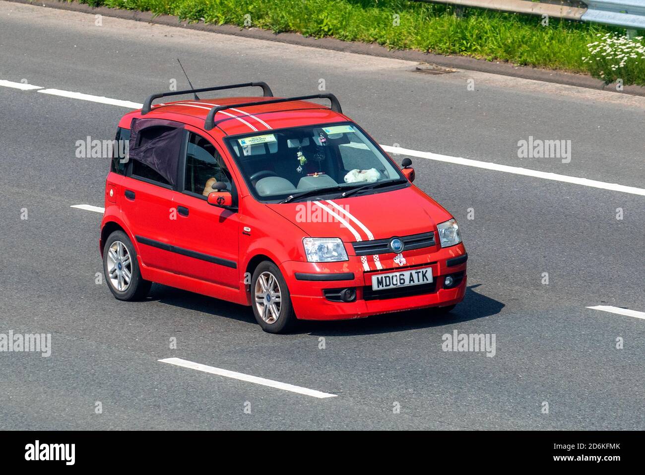 2006 red Fiat Panda Dynamic Multijet; Vehicular traffic, moving vehicles, cars, vehicle driving on UK roads, motors, motoring on the M6 motorway highway UK road network. Stock Photo