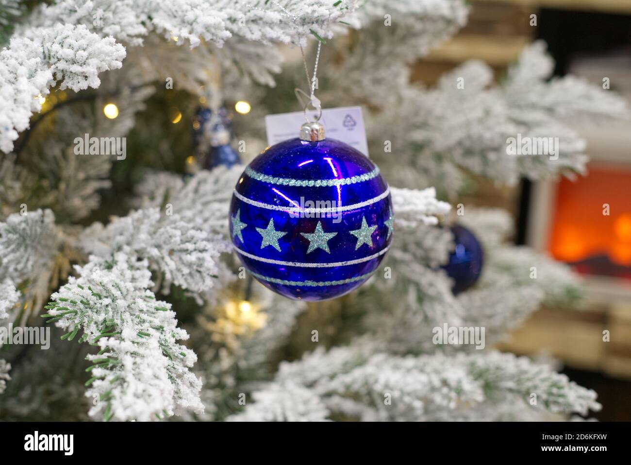 blue ball with stars hanging on the Christmas tree Stock Photo