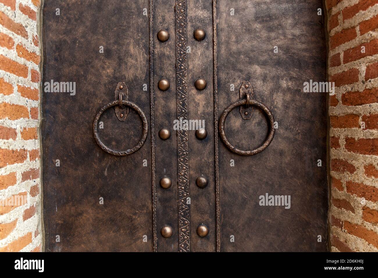 Round iron handles on an old metal gate. Antique iron door handle Stock