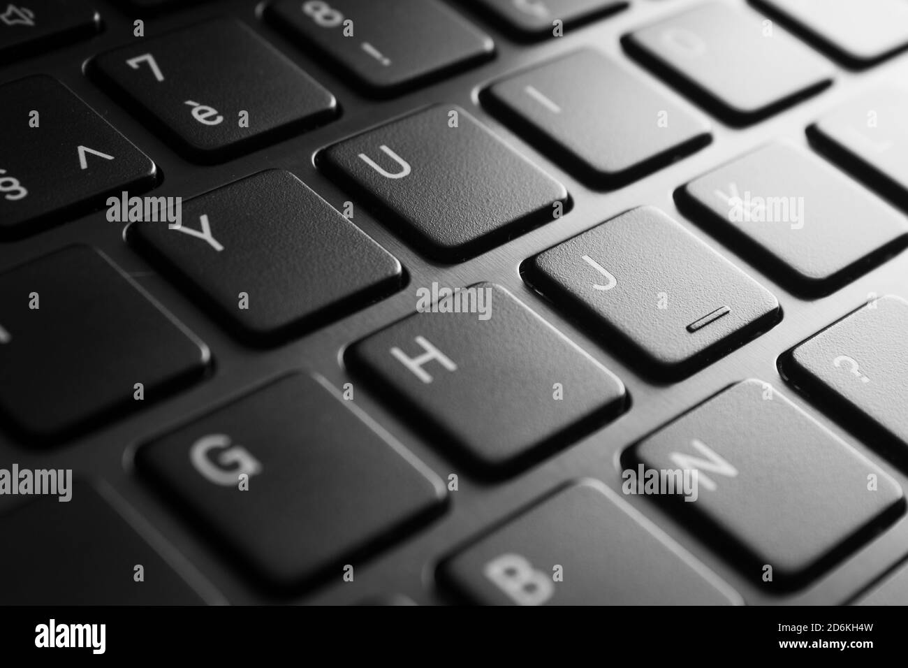 Laptop keyboard close-up in black and white with selective focus and brushed aluminium Stock Photo