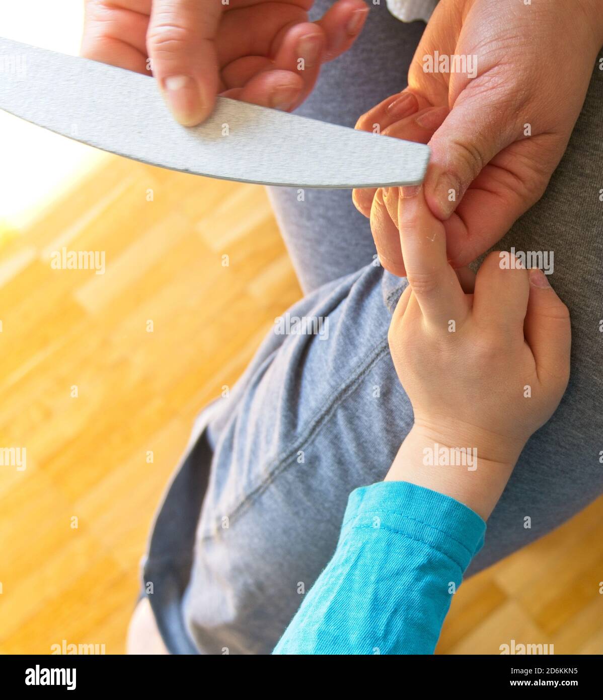 Hands of a woman filing the toenails of a child Stock Photo - Alamy