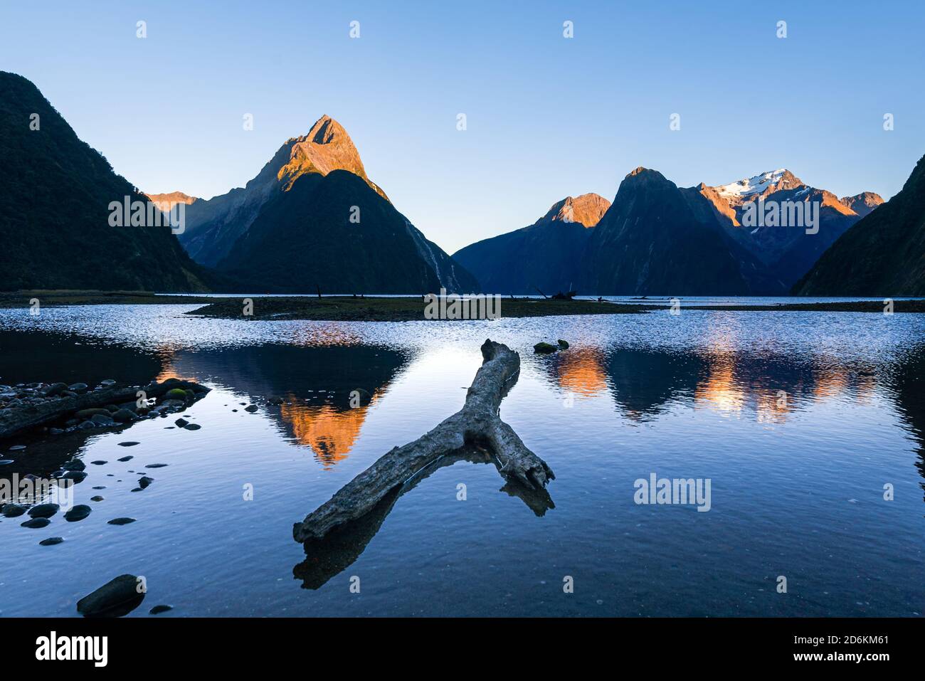 Sunrise in the fiord of Milford Sound with Mitre Peak in Fiordland National Park, New Zealand Stock Photo