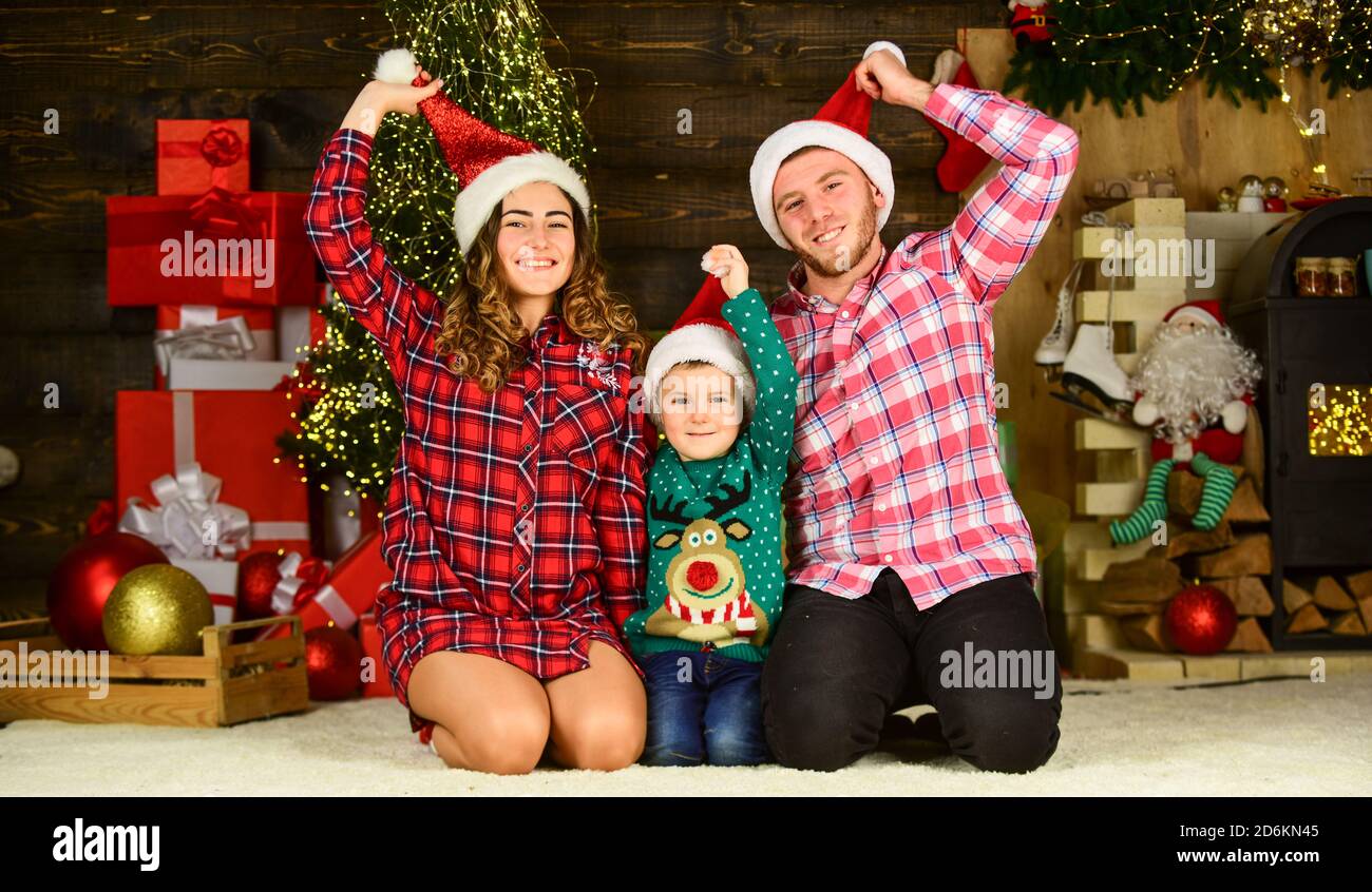 https://c8.alamy.com/comp/2D6KN45/christmas-is-time-for-giving-merry-christmas-mom-dad-and-small-kid-have-fun-happy-family-celebrate-new-year-parents-with-son-wear-santa-hat-father-and-mother-with-child-stay-home-on-holidays-2D6KN45.jpg