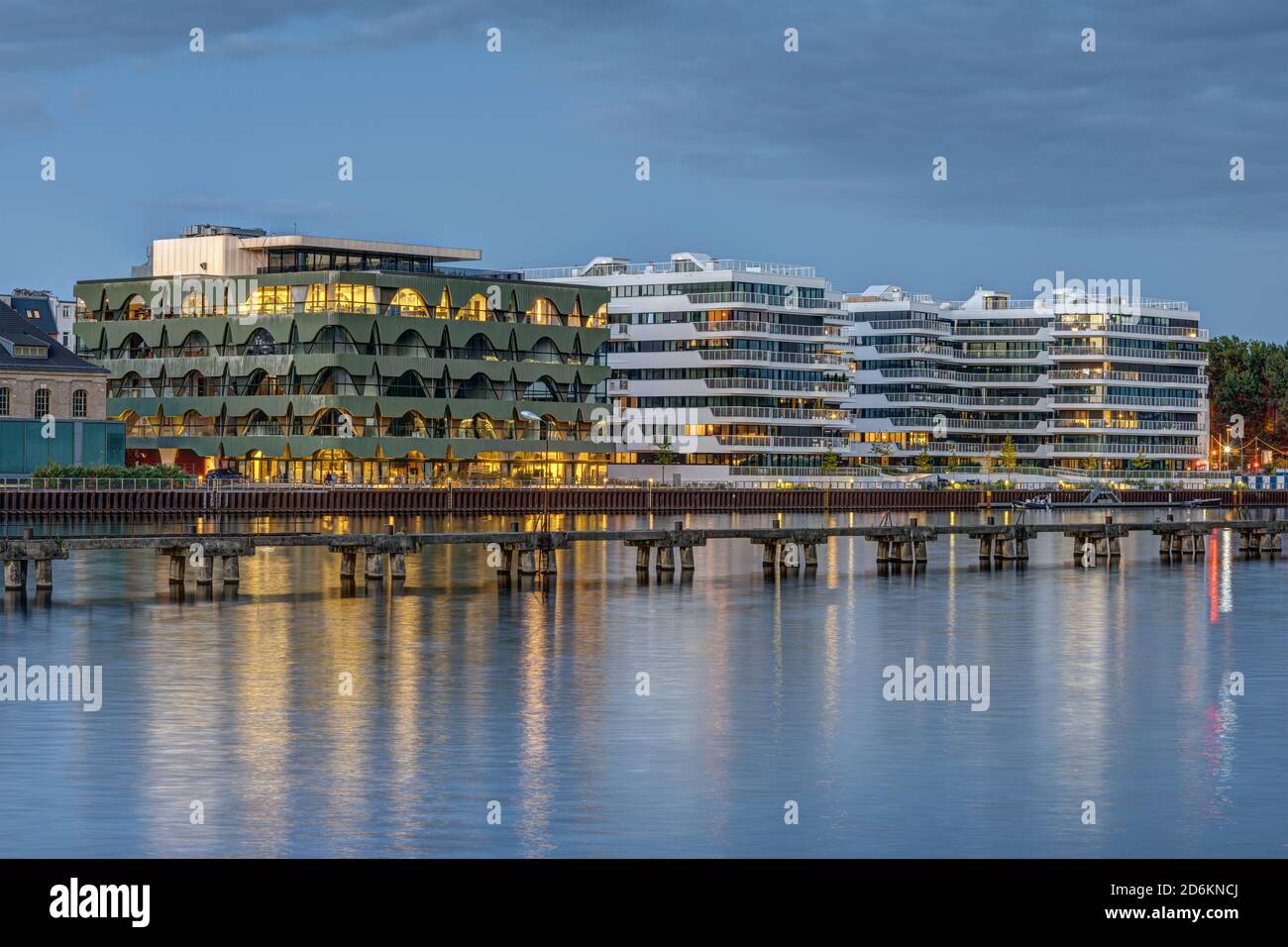 New apartment buildings at the river Spree in Berlin at dusk Stock Photo