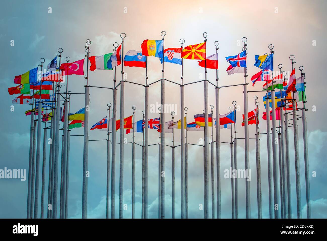 Flags of European states on flagpoles against blue sky background Stock ...