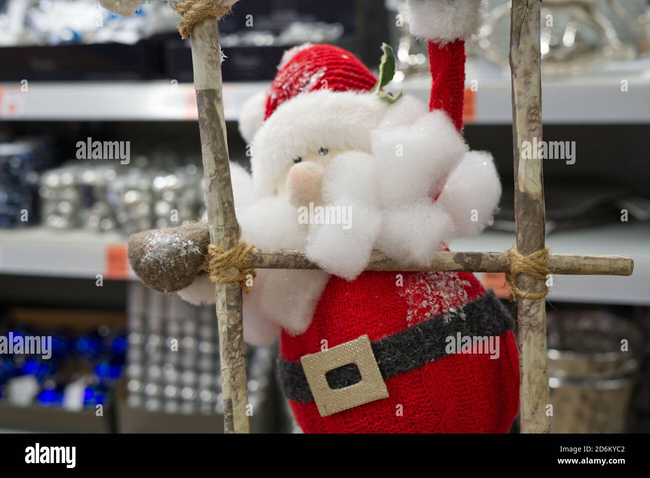 toy santa claus climbs wooden stairs up Stock Photo