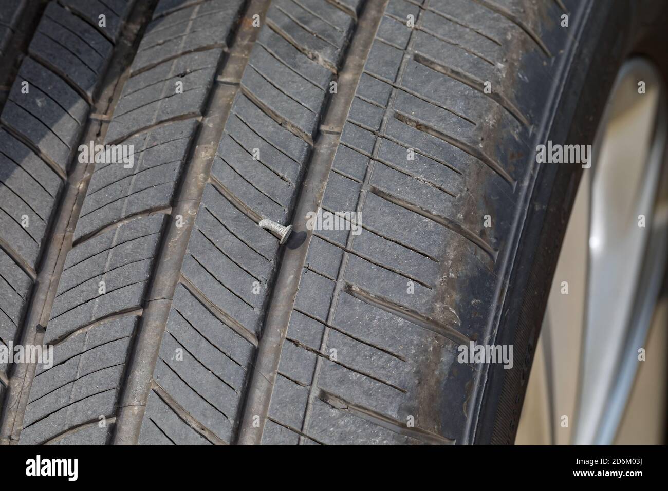 Nail in car tire. Concept of vehicle safety, flat tire, tire maintenance, repair and air pressure Stock Photo