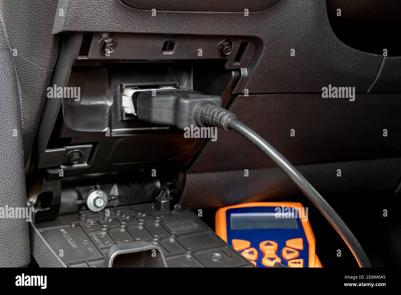 Engine scan tool plugged into car computer connection. Concept of automotive repair, maintenance, service and vehicle check engine light. Stock Photo