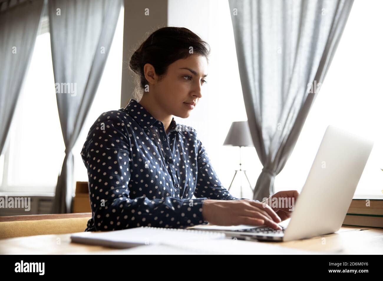 Indian business woman sit at desk working on laptop Stock Photo - Alamy