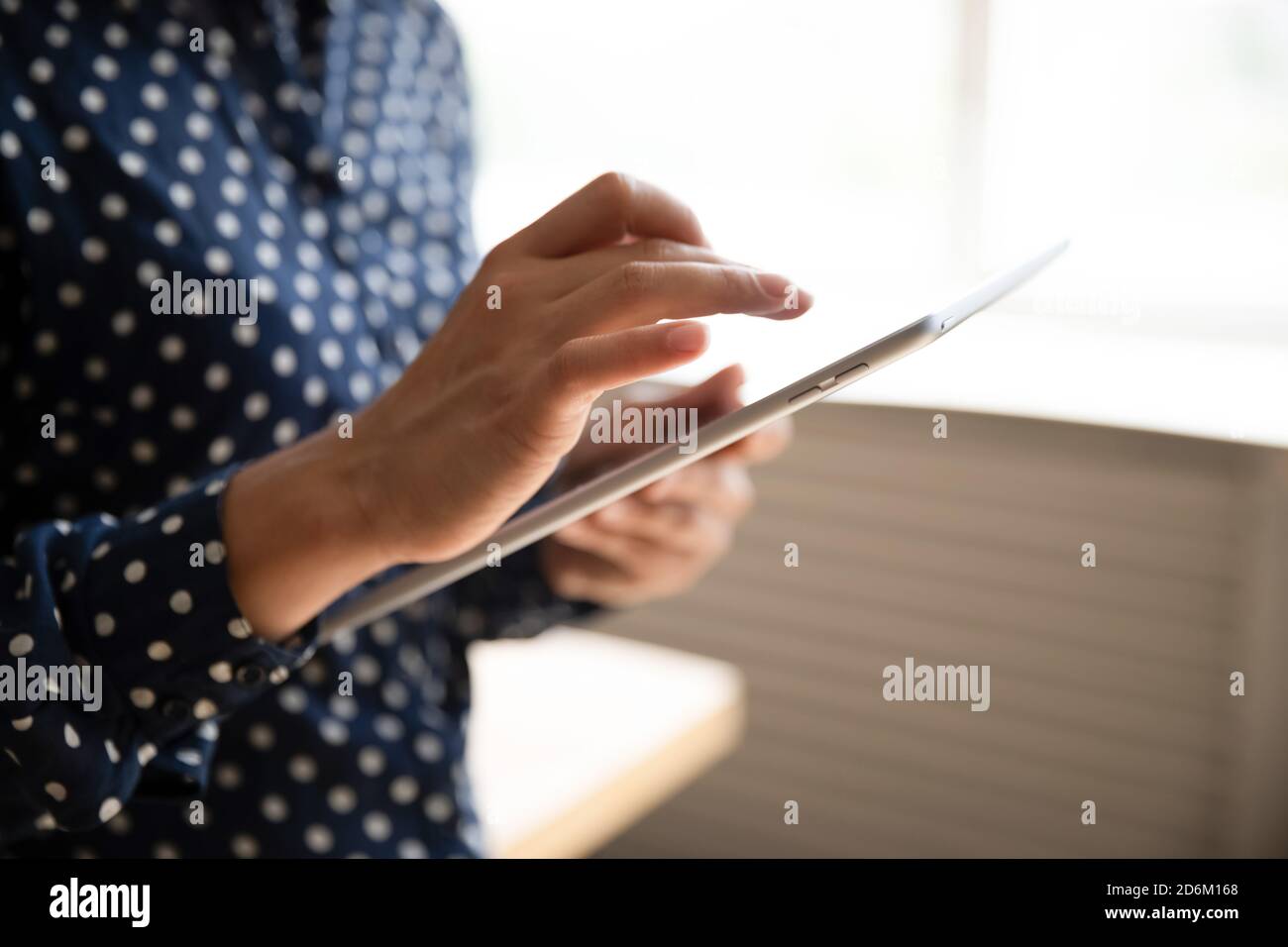 Cropped closeup view female hands using tablet gadget Stock Photo