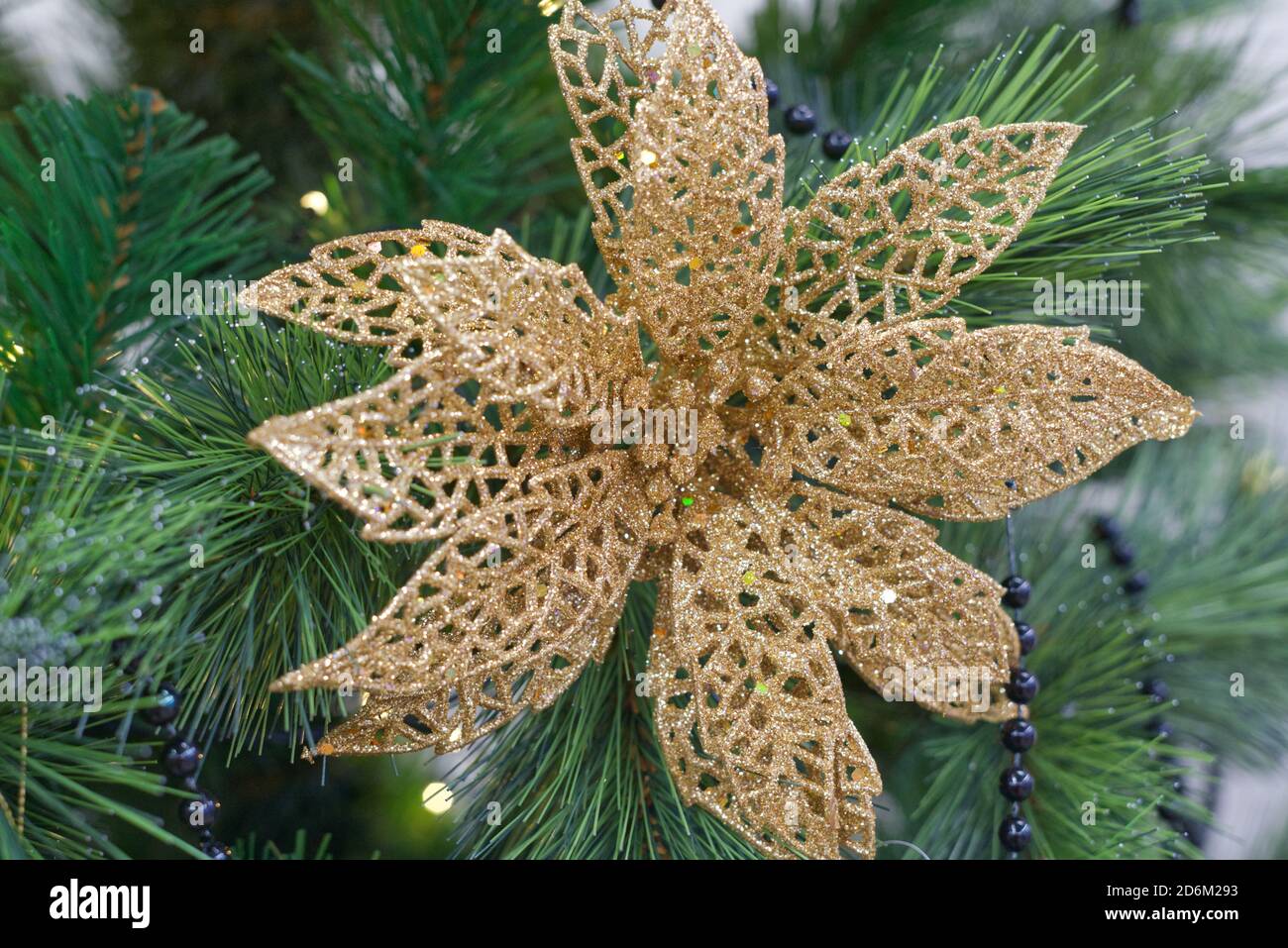 Christmas tree toy in the form of a golden flower hanging on the ...