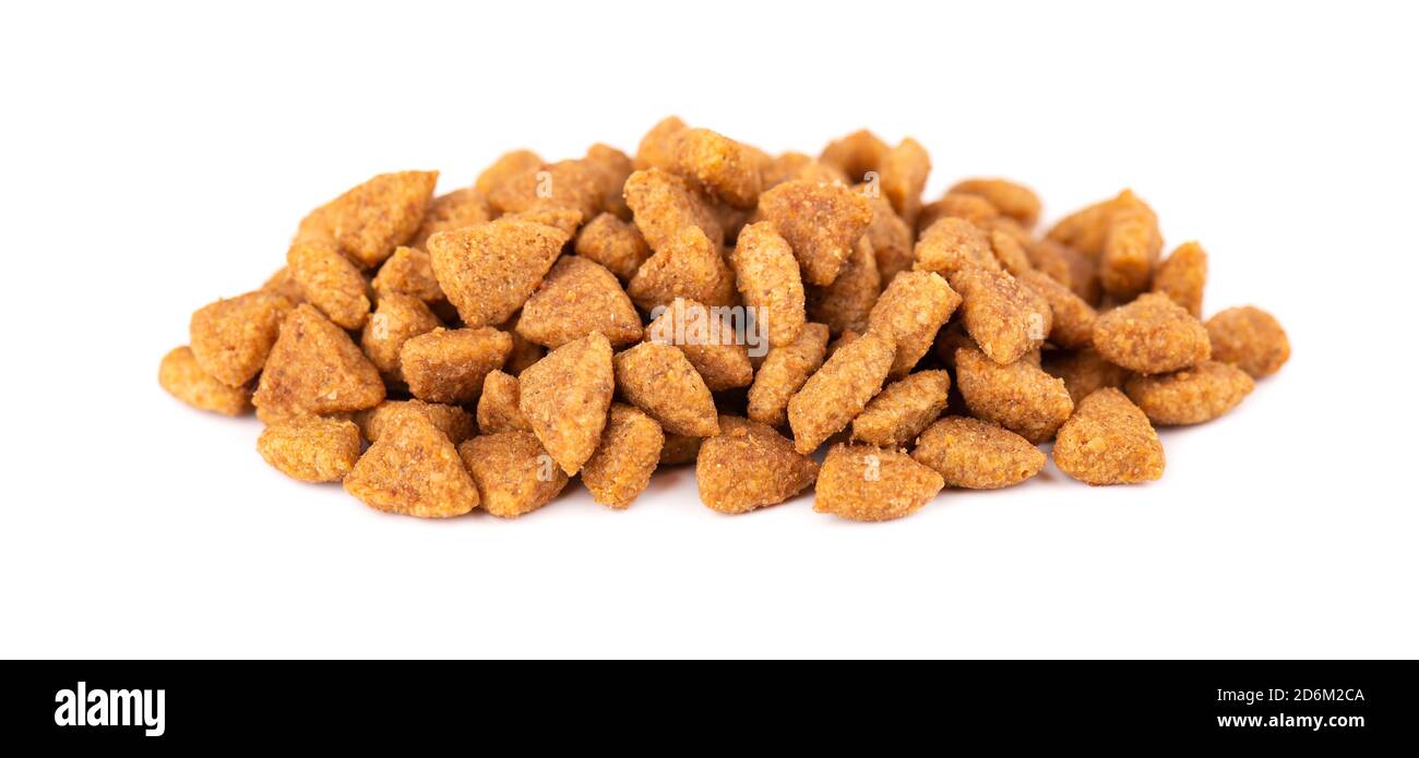 Dry pet food, isolated on white background. Pile of granulated animal feeds. Granules of good nutrition for dogs and cats. Stock Photo