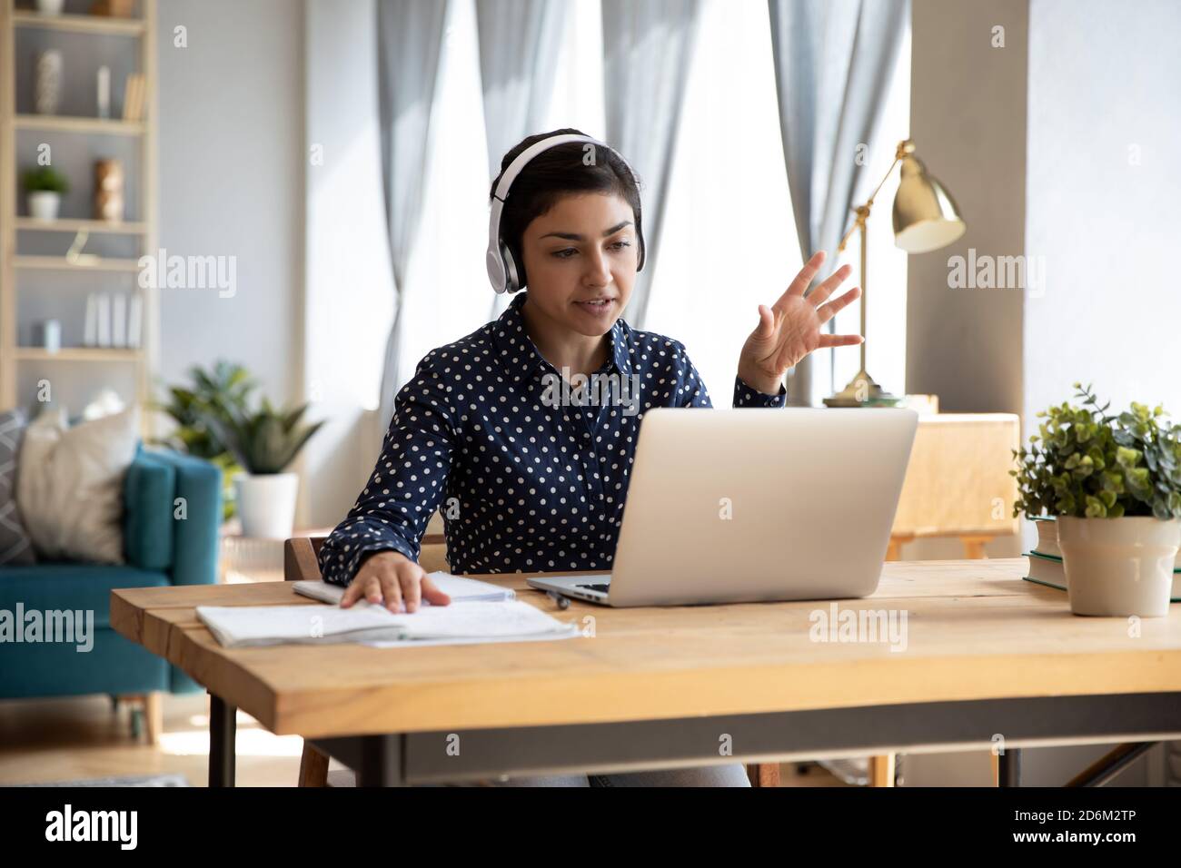 Indian student wear headphones use laptop e-learning remotely by videocall Stock Photo