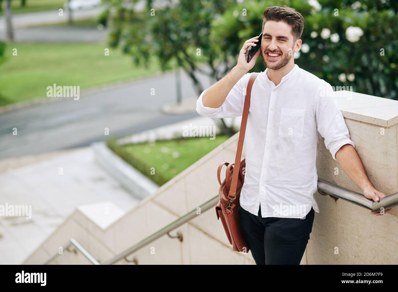 Cheerful man talking on phone Stock Photo