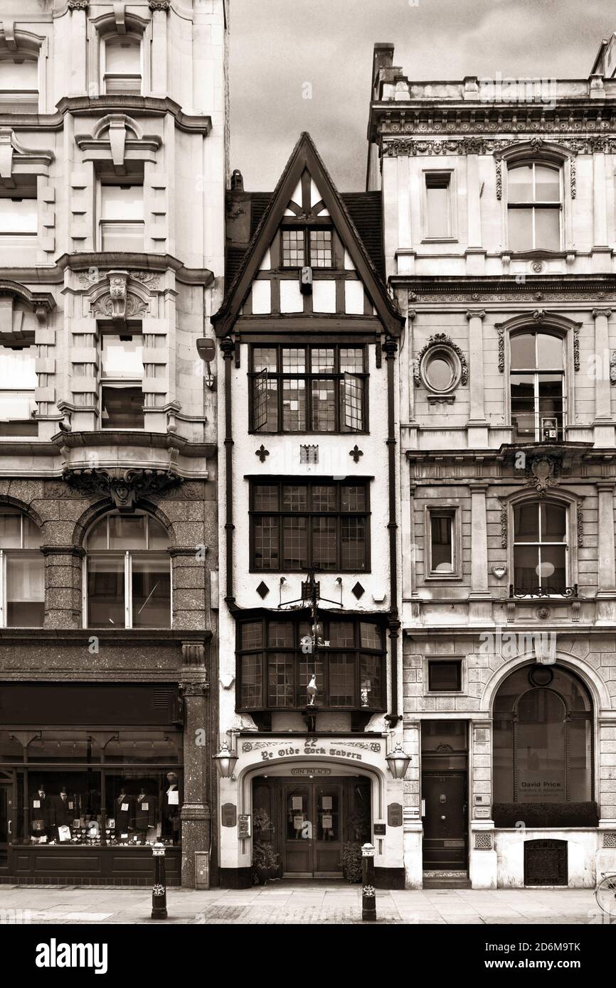 The tall and thin Ye Olde Cock Tavern in Fleet Street, squeezed by modern London buildings. Stock Photo