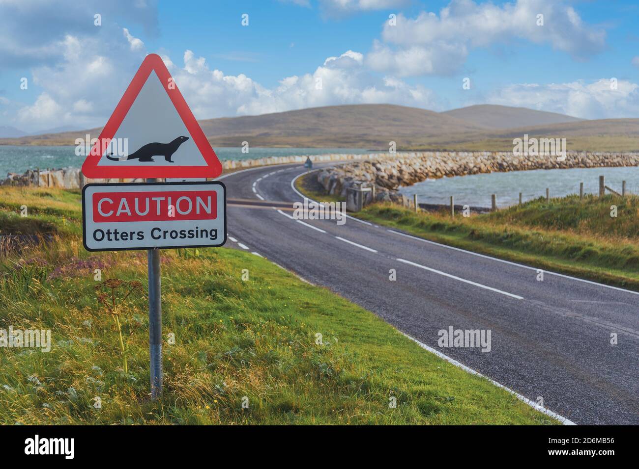 Caution Otters Crossing red triangle road sign by causeway, North Uist Outer Hebrides Western Isles Scotland UK Britain Stock Photo