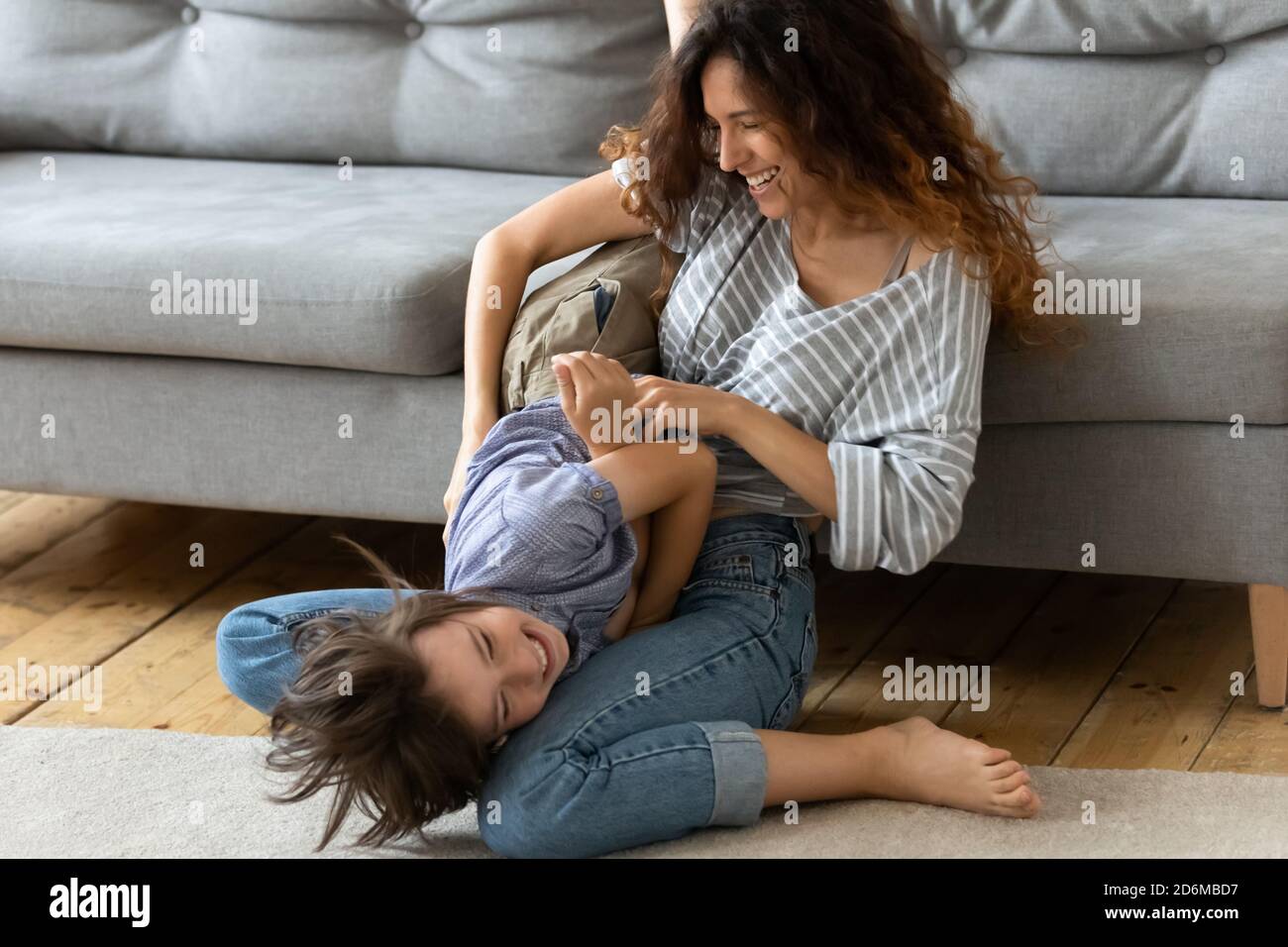 Happy mother and little son having fun together, tickling Stock Photo