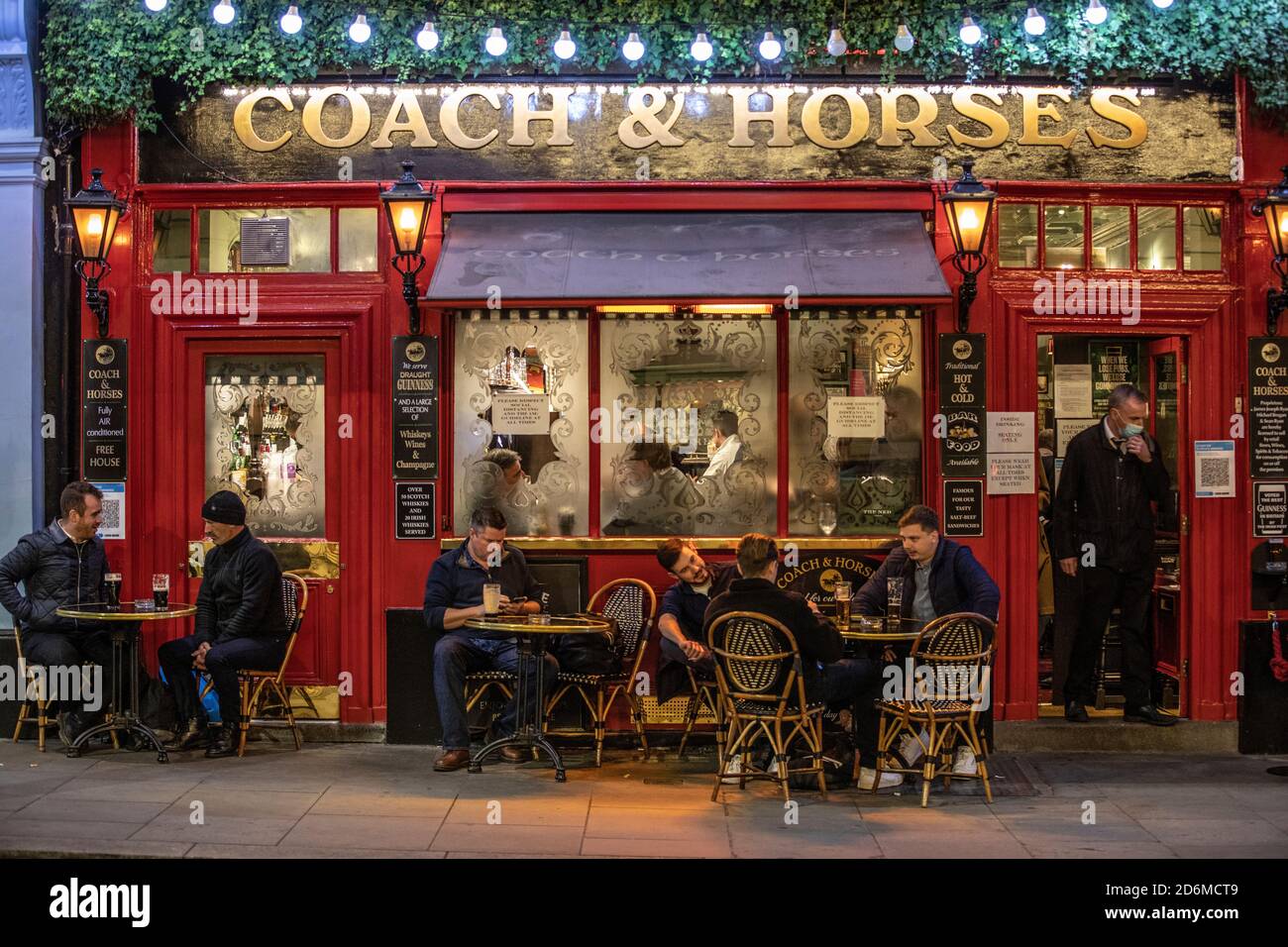Drinkers at the Coach & Horses Pub in Covent Garden, during the last night before the latest Tier 2 Coronavirus Lockdown restrictions are enforced. Stock Photo