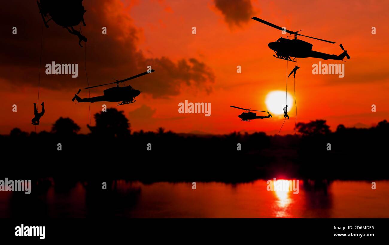 soldier silhouette climb down from helicopter on sunset Concept stop warfare with copy space add text Stock Photo