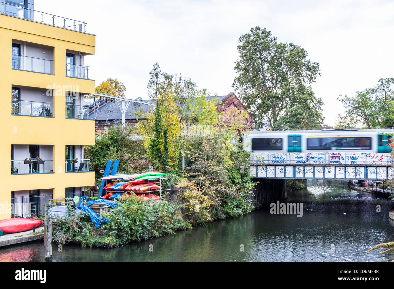 An overground train crossing a bridge over Regent's Canal in Camden Town, London, UK Stock Photo