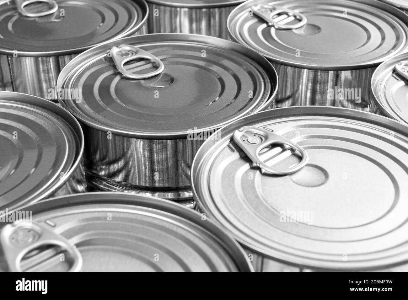 Close up photo of aluminium cans background with opener. Aluminium cans black and white. Aluminium beverage cans top view. Drink can. Metal containers Stock Photo