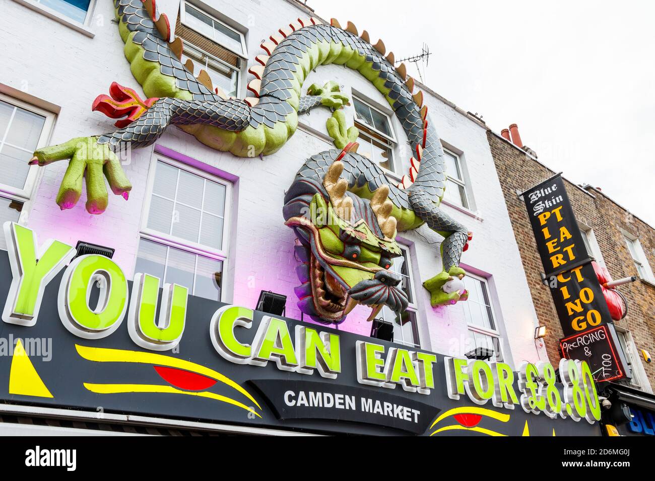 A large sculpted dragon motif on the facade of Max Orient, a Chinese buffet on Camden High Street, London, UK Stock Photo