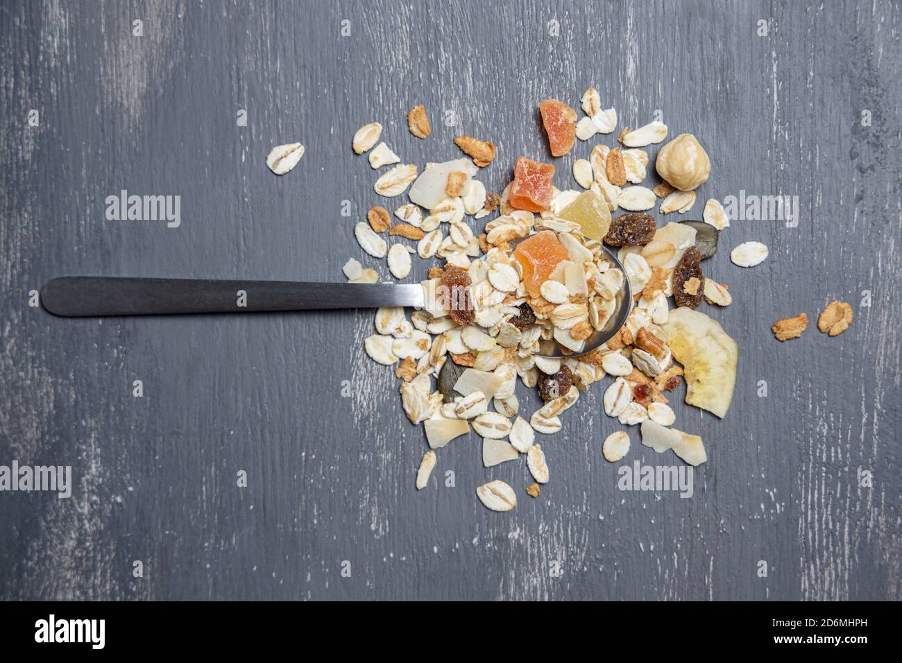 Silver spoon with muesli on gray background Stock Photo