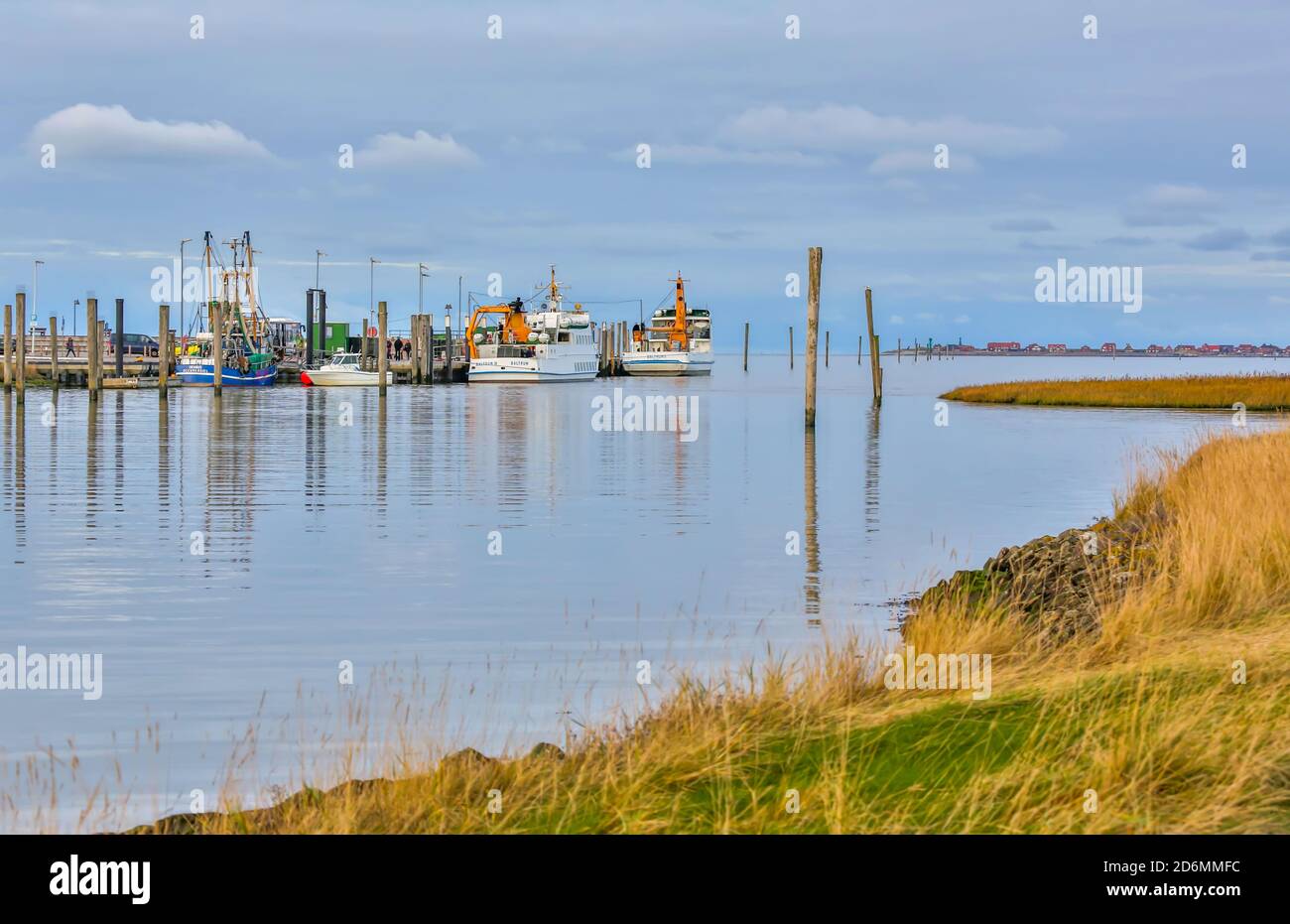 Neßmersiel is located directly on the North Sea in East Friesland. The ferries in small ferry ports bring passengers to the island of Baltrum. Stock Photo