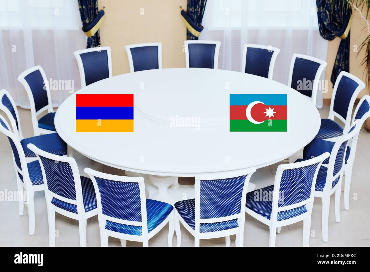 Flags of Azerbaijan and Armenia at the round table. The truce of the warring parties or diplomatic negotiations Stock Photo